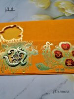 Side-Angle-Of-Yellow-Piano-style-paper-Scroll-with-Om-GAnesh-Hindu-marriage-card-1.jpg