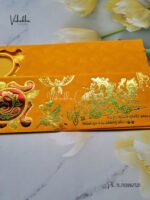 Side-Angle-Of-Yellow-Piano-style-paper-Scroll-with-Swastik-Ganesh-Wedding-card-1.jpg